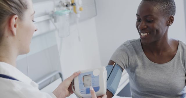 Doctor Checking Blood Pressure of Smiling Patient in Medical Clinic - Download Free Stock Images Pikwizard.com