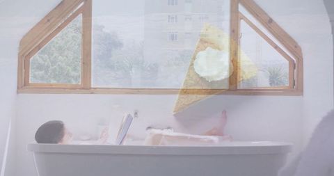 Woman Relaxing in Bathtub While Reading