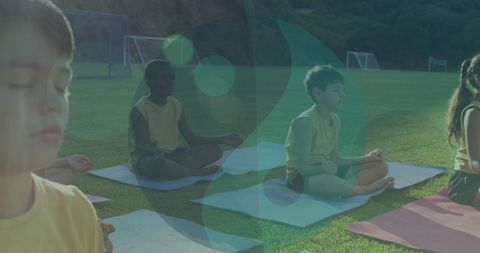 Children Meditating Outdoors with Yin Yang Graphic Overlay