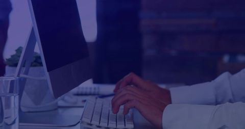 Hands Typing on White Keyboard in Modern Minimalist Workspace with Monitor and Succulent