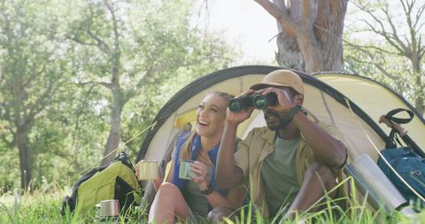Diverse Couple Enjoying Camping and Birdwatching Adventure