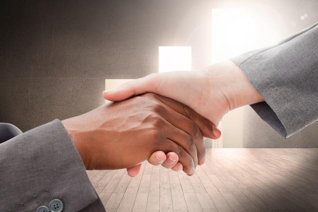 Diverse hands shaking in front of an office setting, indicating successful business partnership and collaboration. Ideal for use in presentations, blogs, and marketing materials focused on teamwork, diversity, inclusivity, corporate agreements, and professional success.