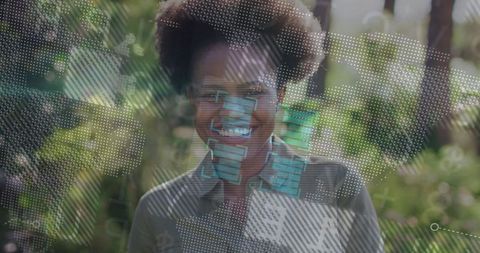 African American Woman Engaging With Futuristic Data Visualizations in Lush Garden