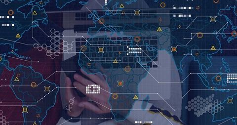 Tapping smartphone over laptop keyboard with global cyber data overlay for security