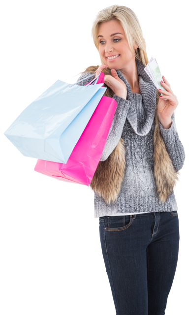 Blonde woman in winter clothes holding shopping bags looking at money with transparent background - Download Free Stock Videos Pikwizard.com