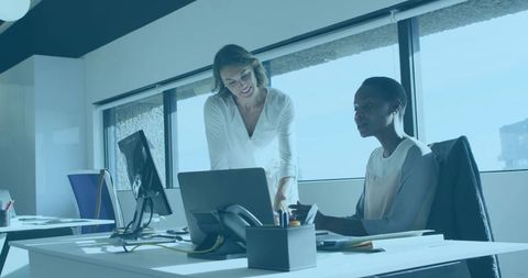 Professional Women Collaborating in Bright Modern Office Setting