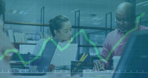 Coworkers Analyzing Financial Data in Modern Office Setting