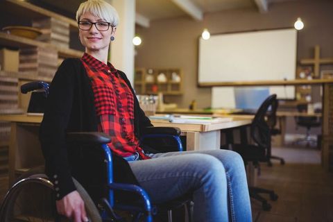 Confident Professional Wheelchair User in Modern Office Workspace