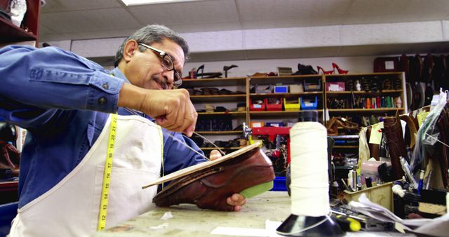 Cobbler stitching a shoe sole with needle in workshop 4k - Download Free Stock Photos Pikwizard.com