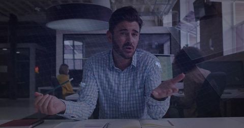 Gesturing Manager Leading Team Discussion in Modern Open-Plan Office Expressing Concern