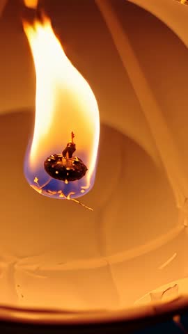 Igniting Wick Sending Flame Upward Inside Hanging Paper Lantern With Glowing Fuel Bead
