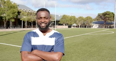 Athletic Man Smiling Confidently on Rugby Field