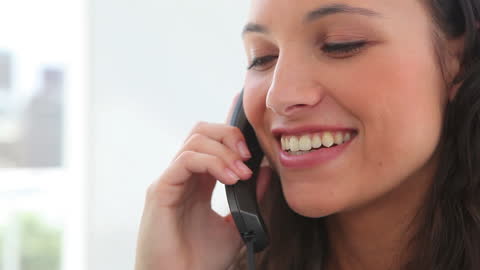 Young Woman Smiling While on a Phone Call in Office