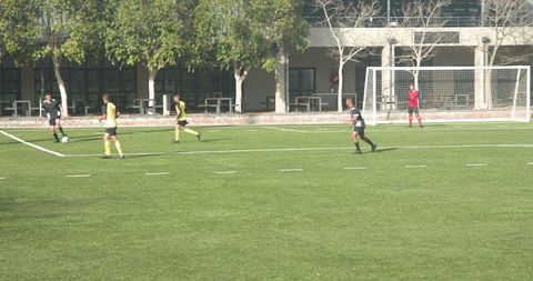 Soccer game on school field highlighting competition and teamwork
