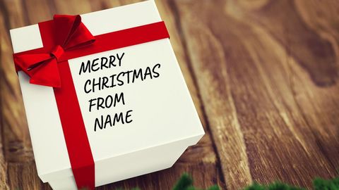 Christmas gift box with red ribbon for personalization