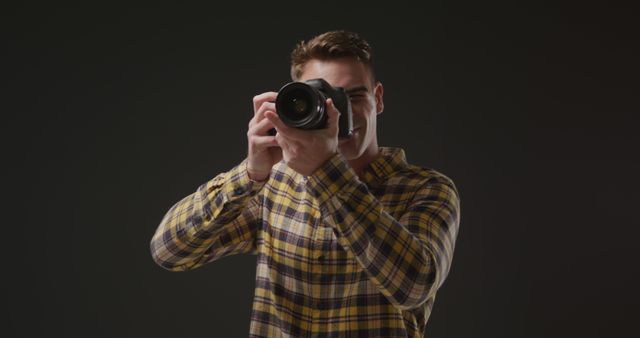 Photographer Holding Camera Against Dark Background - Download Free Stock Images Pikwizard.com