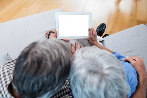 Transparent Screen Displayed by Senior Couple on Couch - Download Free Stock Videos Pikwizard.com