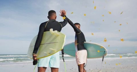 Surfers High-Fiving at Beachside Adventure
