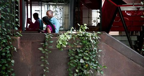 Couple Embracing on Green Balcony Porch Relaxing