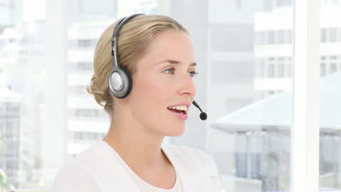 Smiling Woman Using Headset in Modern Office Environment