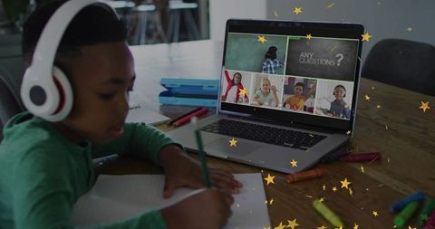 Schoolboy Learning Remotely with Headphones and Laptop