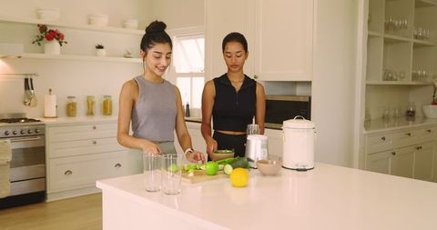 Diverse Female Friends Making Healthy Smoothie in Modern Kitchen