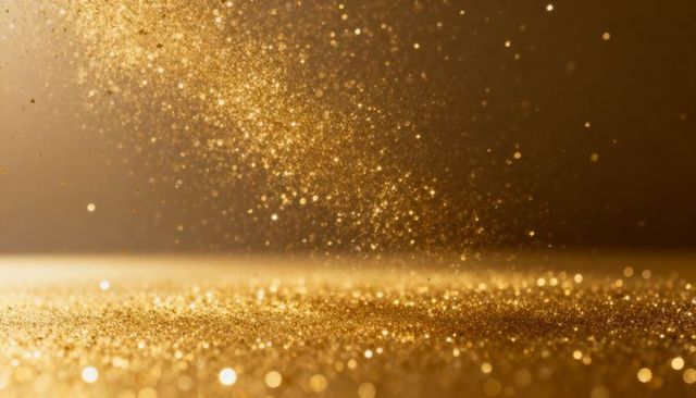 Falling gold glitter with shimmering bokeh, warm metallic sparkle and festive shimmer glow