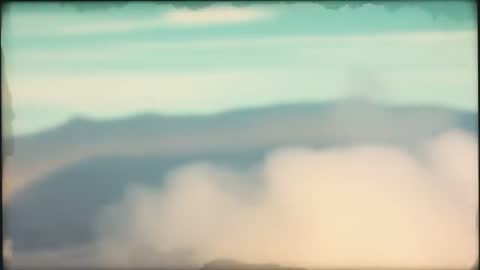 Fog Drifting Over Mountain Ridge at Summit with Turquoise Sky and Soft Vignette