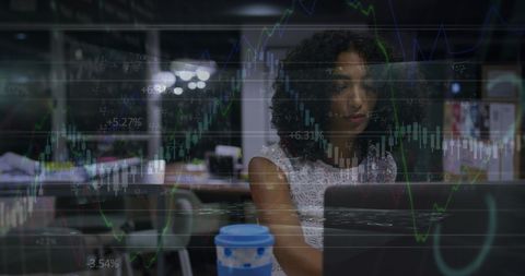 Businesswoman Analyzing Financial Graphs Late at Night