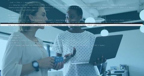 Women Collaborating Over Laptop with Code Overlay in Modern Office Technology Scene