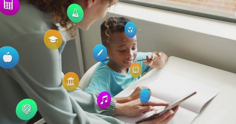 Diverse teacher helping student with tablet learning