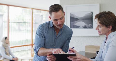 Man Signing Documents in Modern Dental Clinic Reception