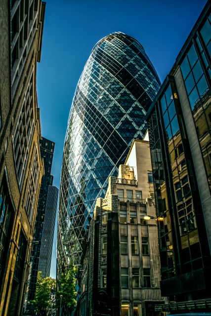 Image depicts modern skyscrapers and the iconic glass building known as The Gherkin in the financial district. Great for illustrating business and finance topics, cityscapes, urban designs, architecture, and real estate advertisements.