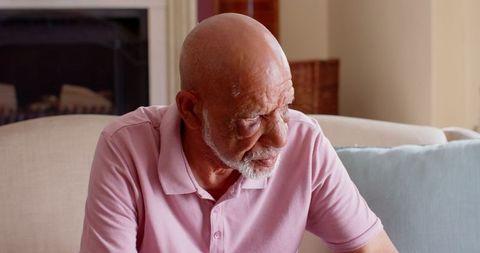 Elderly Man Relaxing Thoughtfully in Modern Living Room
