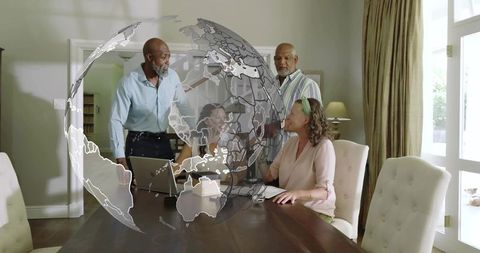 Multigenerational Team Collaborating Around Laptop with Holographic Globe Overlay