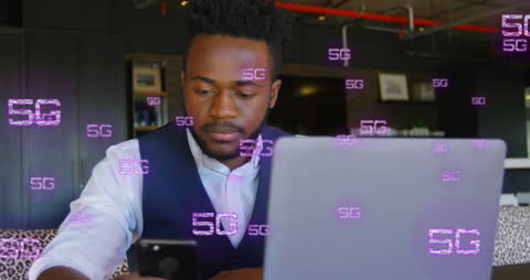 Businessman Utilizing 5G Technology with Laptop and Phone