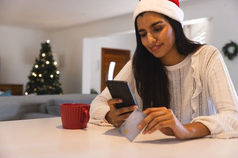 Woman Shopping Online at Home During Christmas Holidays