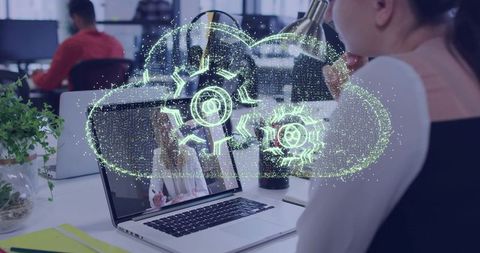 Female professional using laptop with holographic cloud automation and virtual collaboration