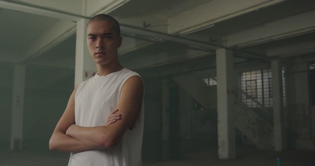 Confident Young Man in Industrial Warehouse - Download Free Stock Images Pikwizard.com