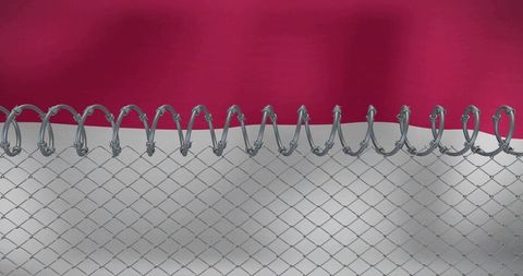 Concertina razor wire capping chain-link fence against two-tone backdrop security