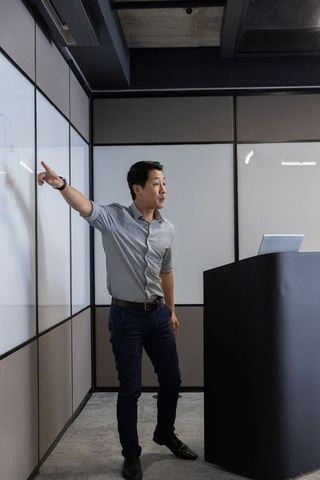 Business Professional Presenting in Modern Conference Room