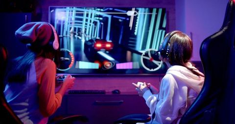 Teen Girls Enthusiastically Gaming Together with Headphones - Download Free Stock Images Pikwizard.com