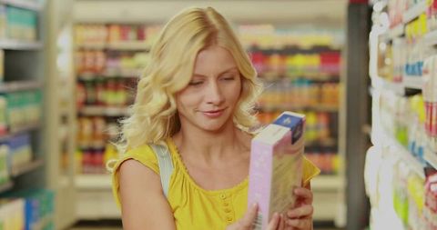 Woman Reading Product Label in Grocery Store Aisle