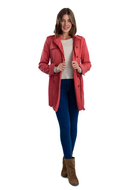 This image features a smiling young woman wearing a red coat, blue jeans, and brown boots, standing against a white background. Ideal for use in fashion catalogs, winter clothing advertisements, lifestyle blogs, and promotional materials for casual wear. The cheerful expression and stylish outfit make it suitable for conveying a sense of confidence and trendiness.