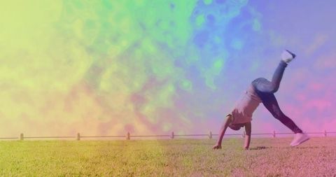 Child Enjoying Cartwheel on Grassy Field with Vivid Colors