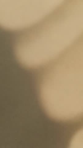 Capturing golden-beige abstract blur vertical video for minimal textured background