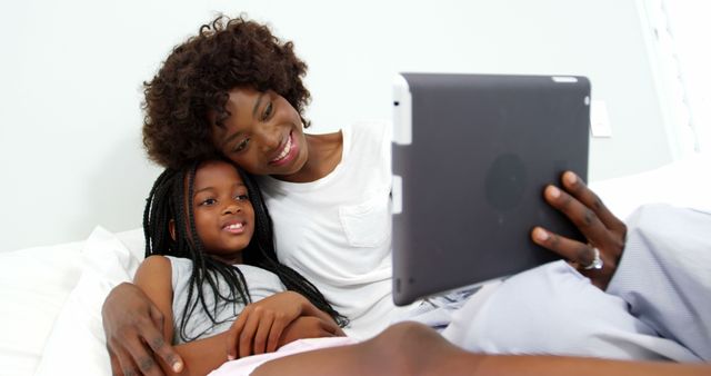 Mother and Daughter Smiling While Using Tablet at Home - Download Free Stock Images Pikwizard.com