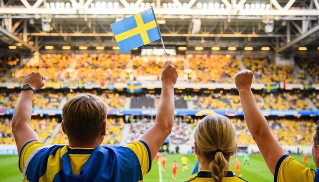 Swedish soccer fans cheering and waving flag in vibrant packed stadium crowd matchday