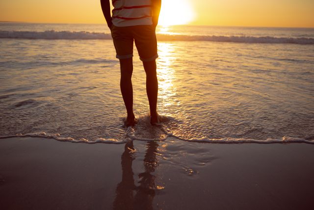 Thoughtful man standing with hands in pocket on the beach - Download Free Stock Photos Pikwizard.com