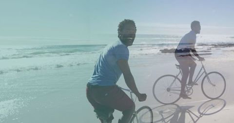 Joyful Caucasian Man Biking at Beach During Vacation Overlays